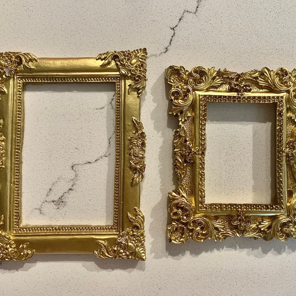 Set of 2 gold open back frames. Resin.